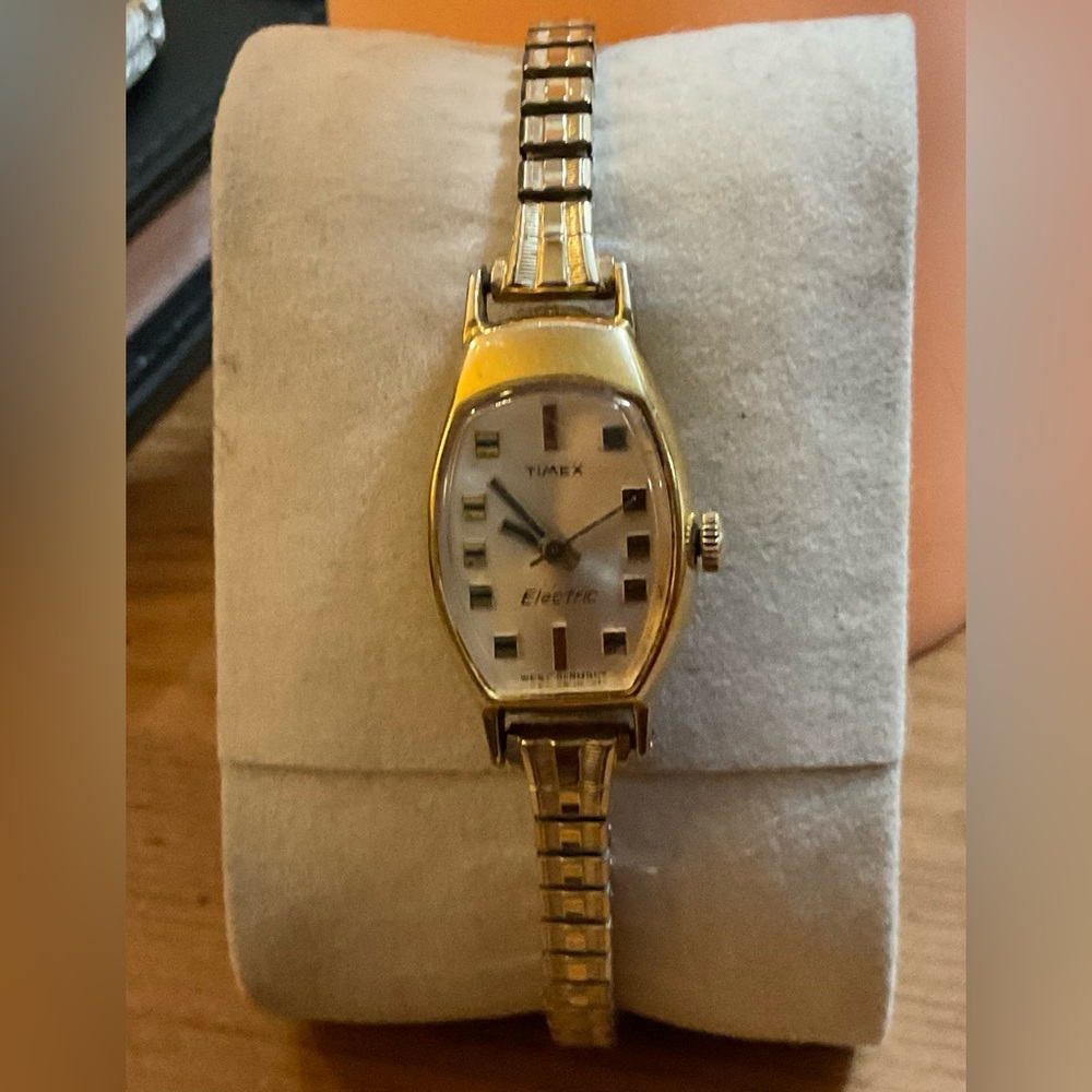Timex: Woman’s vintage (70S) gold filled electric wrist watch with thin band.